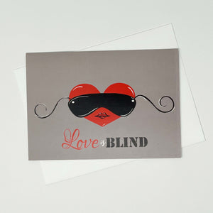 Greeting-Card-with-a-heart-wearing-Blind-folds-flay-lay