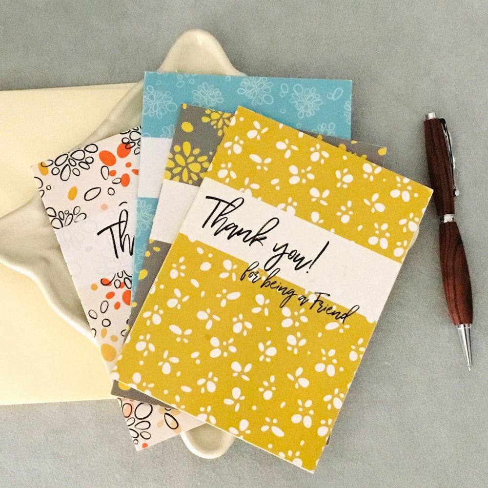 Thank You greeting card with a modern yellow floral pattern on a gray background, featuring elegant script and bold typography. 