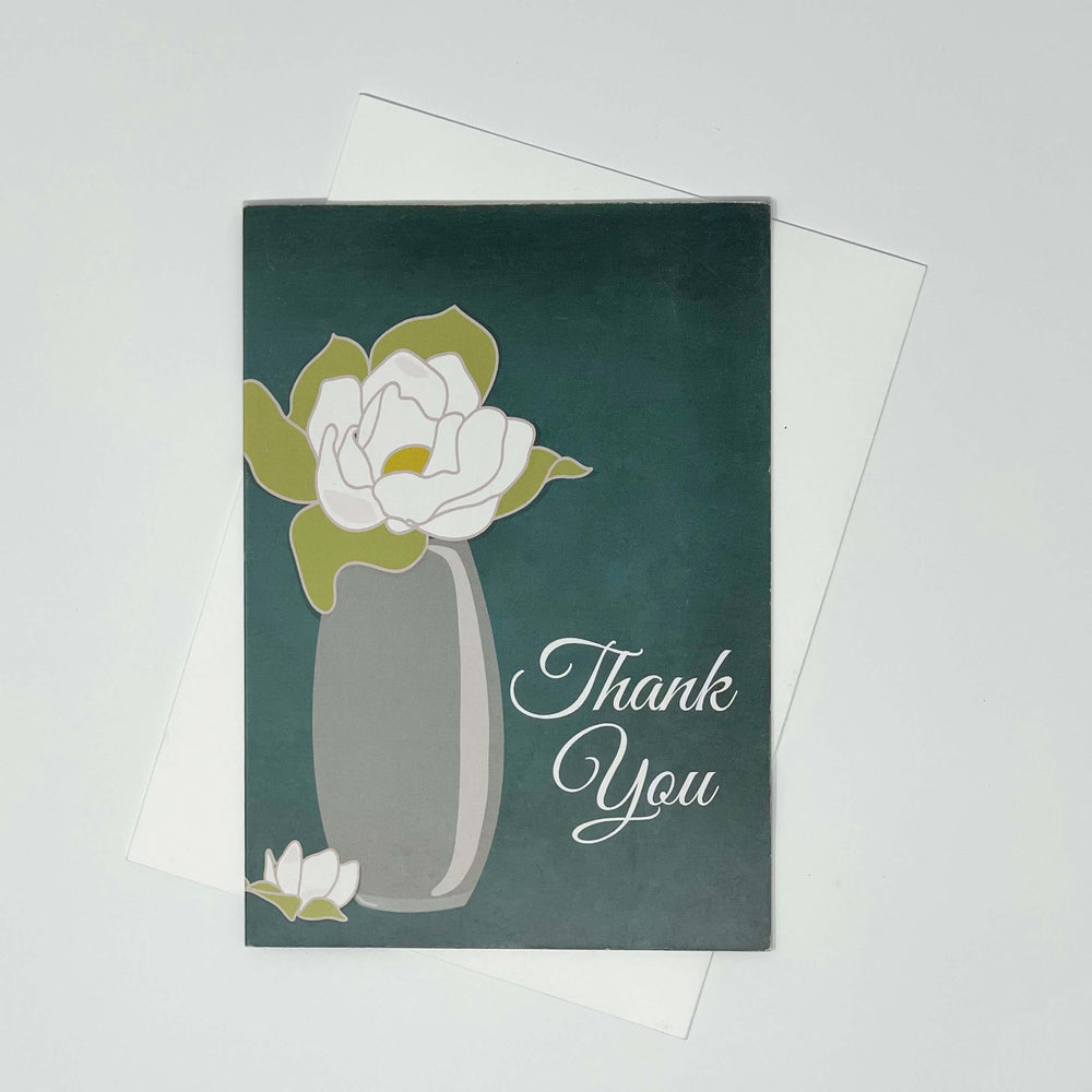 Thank-you-card-featuring-a-graceful-magnolia-flower-flat-lay. 